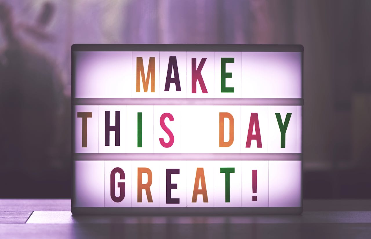 Inspirational sign displaying Make This Day Great in colorful letters.